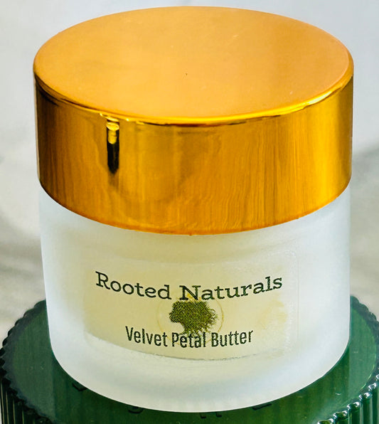 Rooted Naturals Velvet Petal Lip Butter in a frosted glass jar with a gold lid